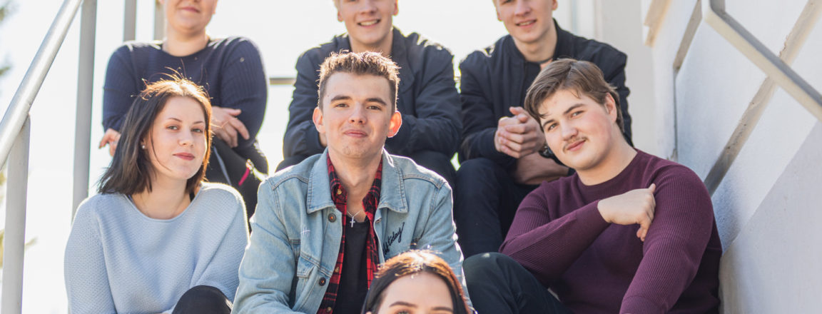 A group of students sitting on the stairs.